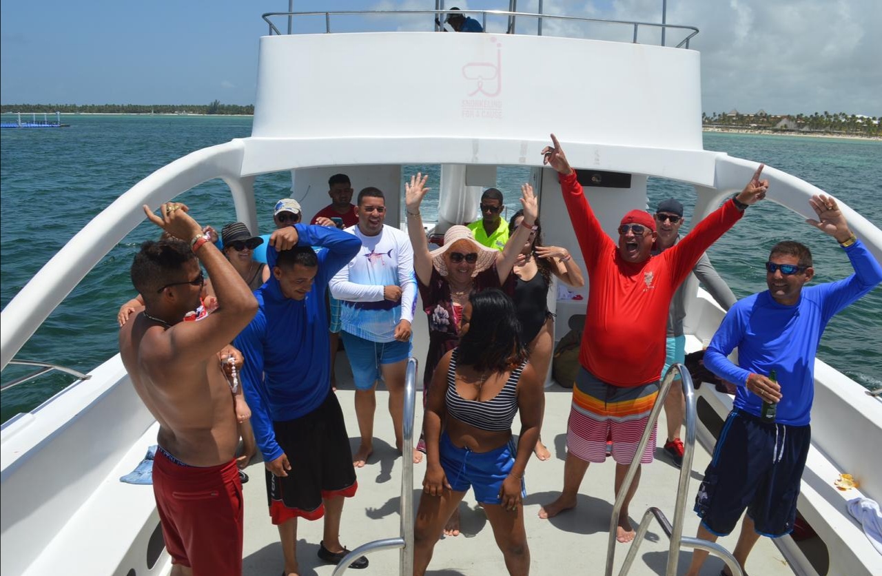 a group of people standing next to a body of water