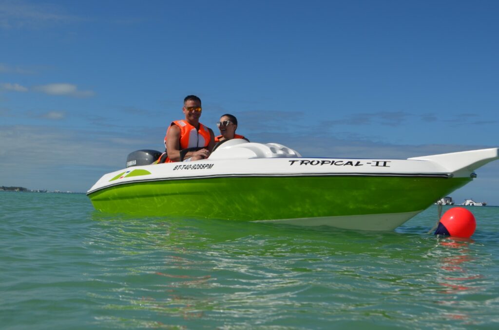 Two people on green speedboat